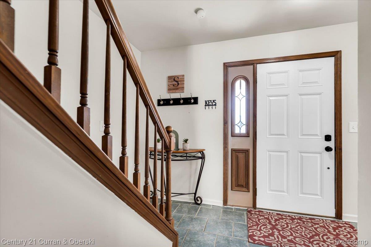 Entryway featuring a paneled white door with a decorative glass sidelight