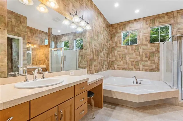 a spacious bathroom with a granite countertop sink a toilet and a mirror