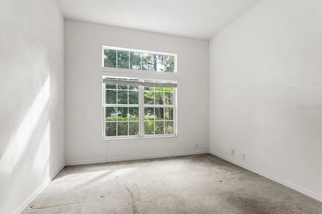 a bathroom with a granite countertop sink a toilet and a mirror