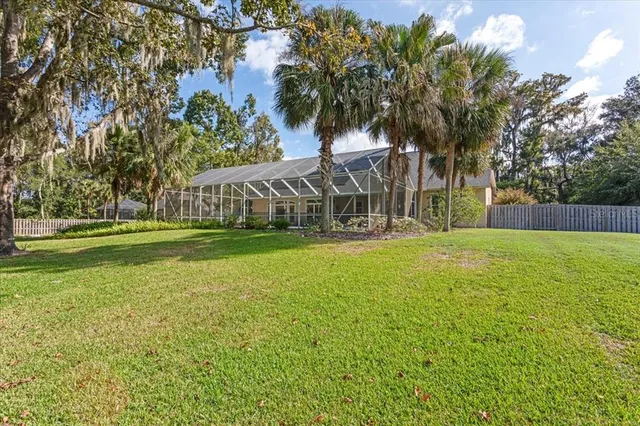 a view of swimming pool with tree s and green space