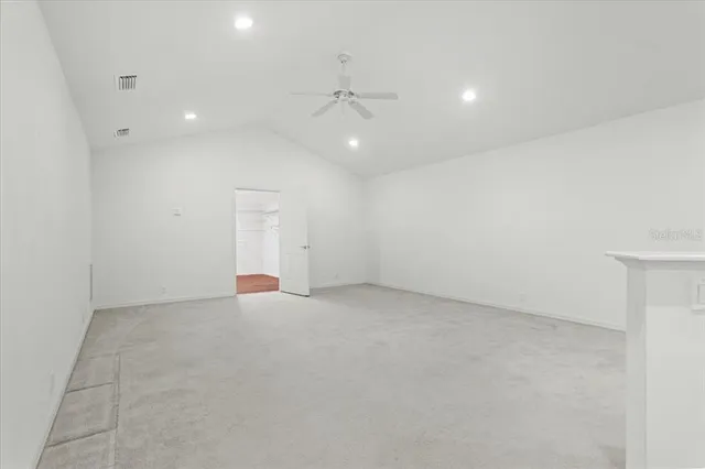 a view of a room with wooden floor and windows