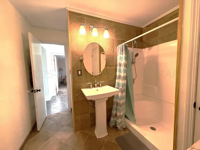 a bathroom with a sink toilet and a mirror