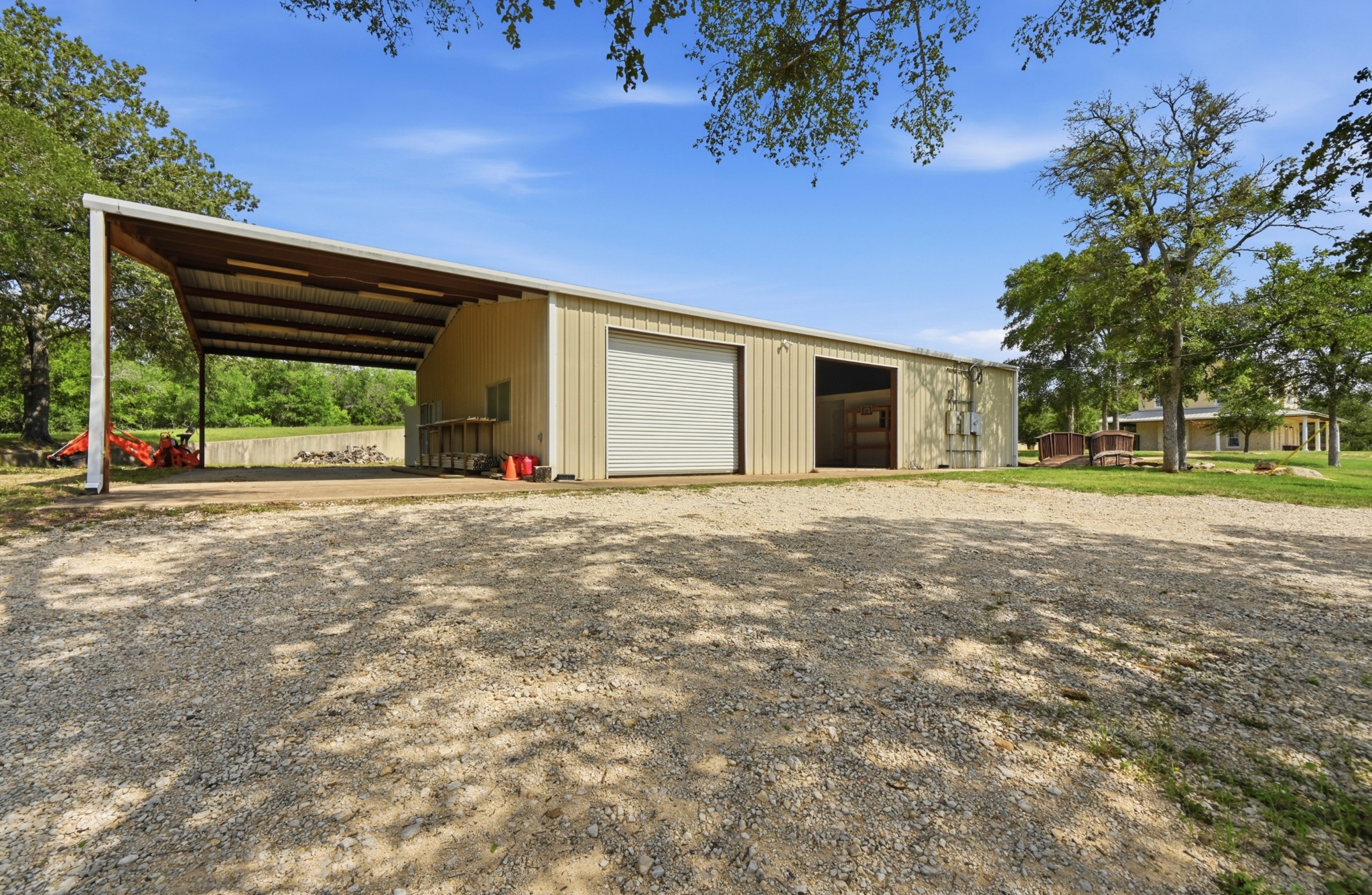 1175 Southern Way Luling, TX 78648 - Photo 8 of 40 A spacious workshop with an attached carport offers ample utility and storage space.