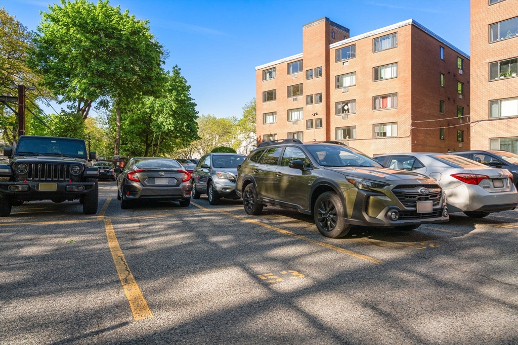 205 Kent Street, Unit 48 Brookline, MA 02446 - Photo 10 of 10 a view of a cars parked in front of a building