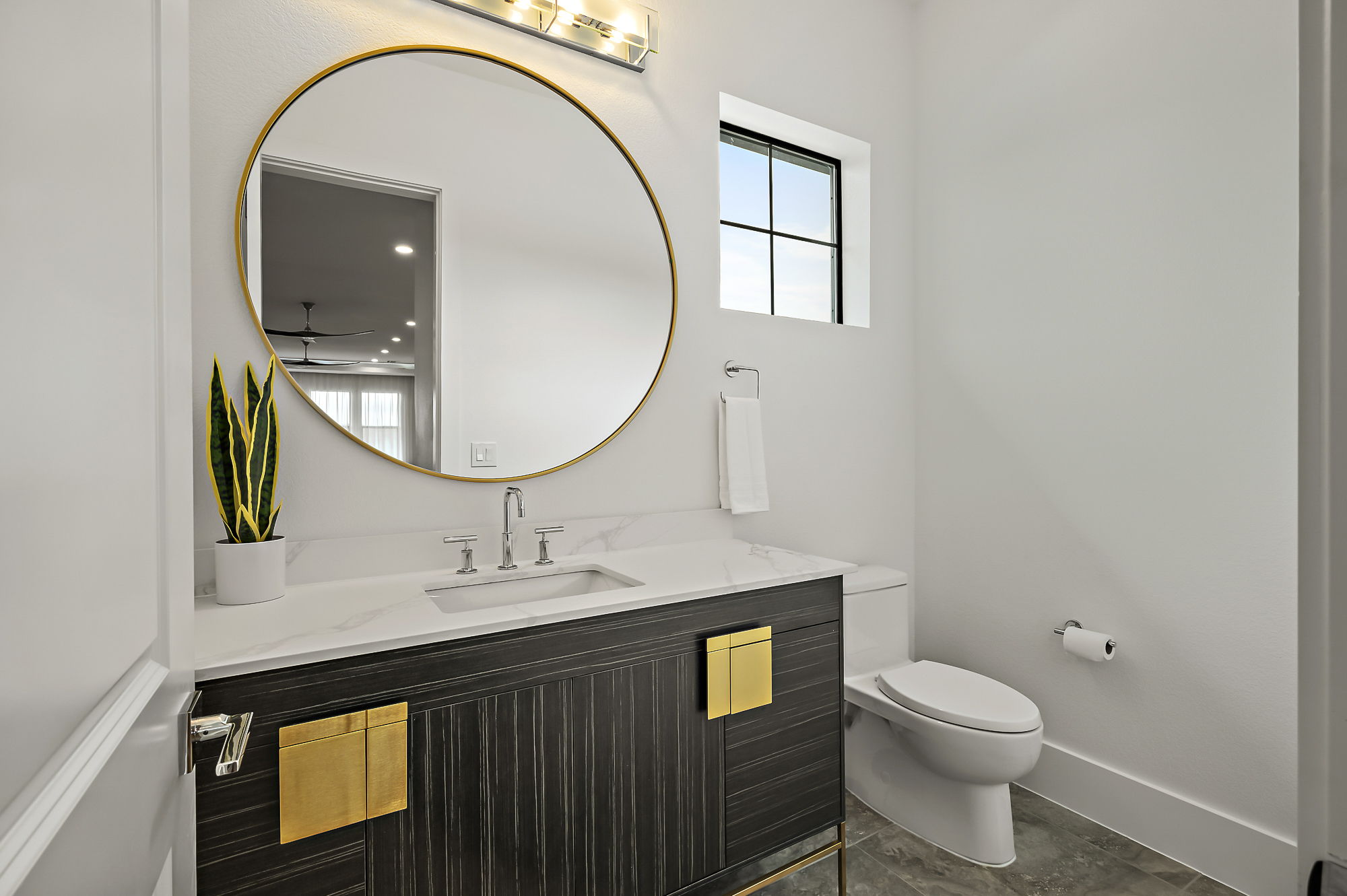 10211 Thistle Ridge Austin, TX 78733 - Photo 25 of 39 Half bath with plenty of natural light, toilet, vanity, and baseboards