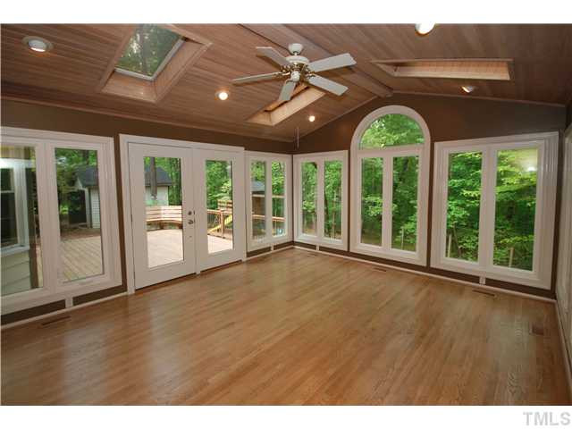 8304 Heel Stone Court Raleigh, NC 27613 - Photo 12 of 25 Enjoy the views from this beautiful Sun Room that features skylights, overhead lighting, new hardwood floors, a vaulted ceiling. Sun Room