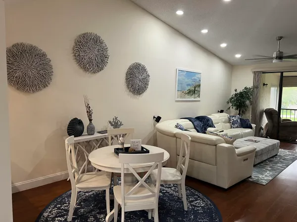 a living room with furniture rug and wooden floor