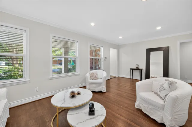 a living room with hard wood floors and a wooden floor