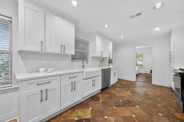 a kitchen with stainless steel appliances a refrigerator sink and cabinets