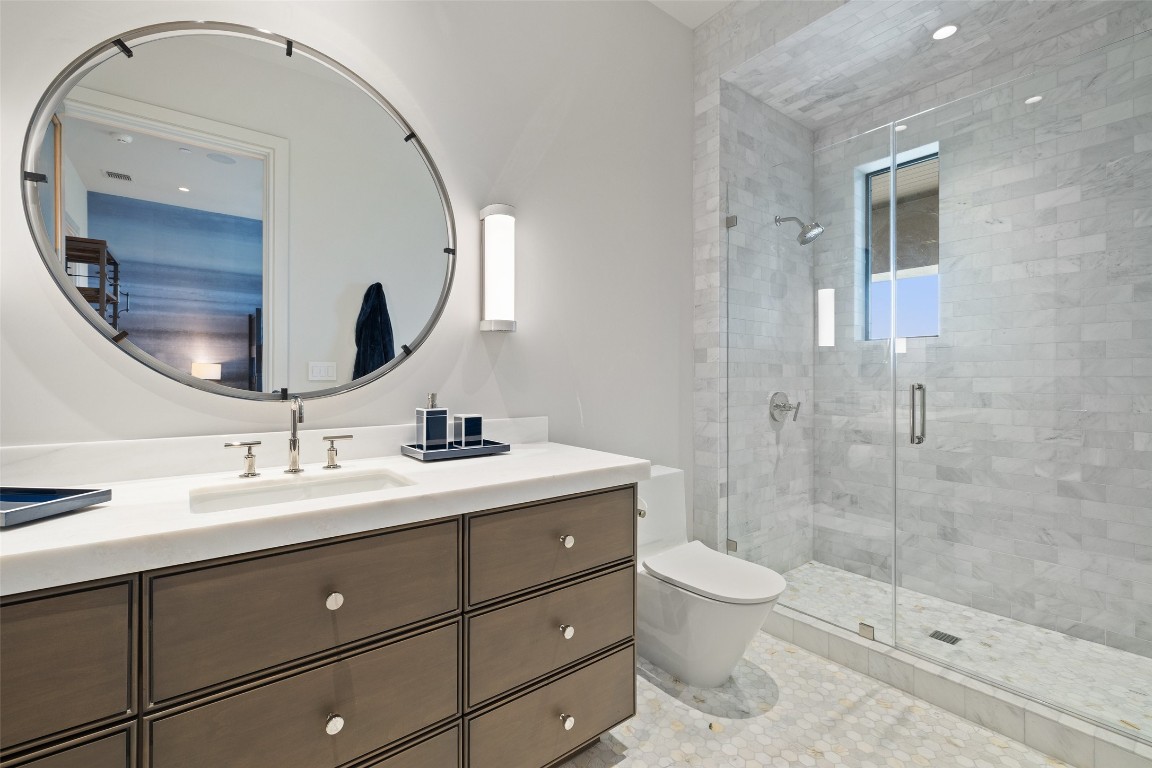 4901 Mirador Drive Austin, TX 78735 - Photo 25 of 35 a bathroom with a double vanity sink toilet mirror and shower