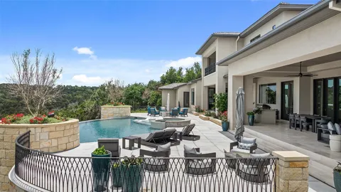 a view of a patio with couches table and chairs and potted plants