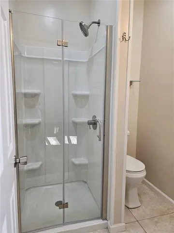 a bathroom with a shower and toilet