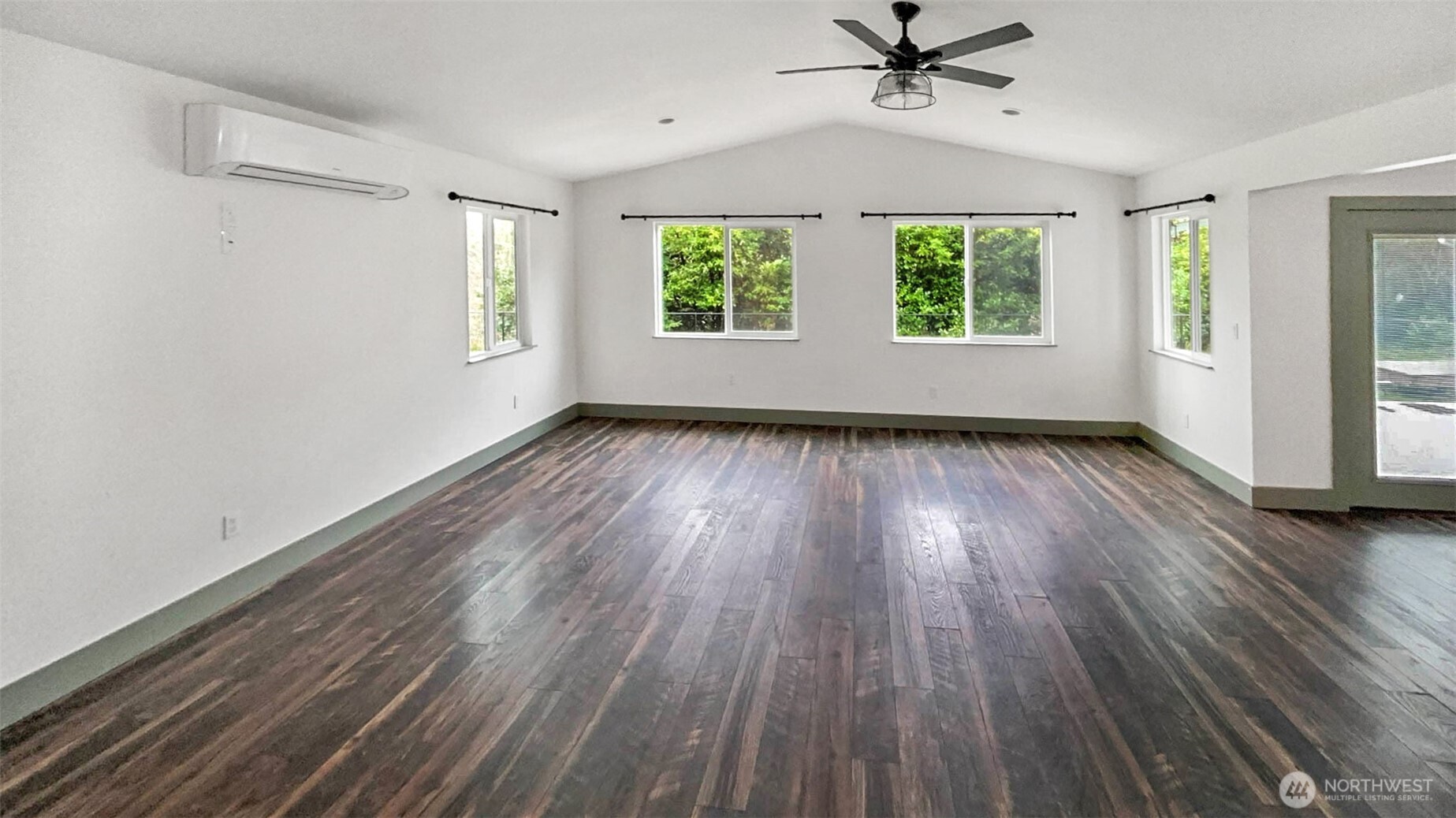 280 Devonshire Road Montesano, WA 98563 - Photo 7 of 20 an empty room with wooden floor windows and a ceiling fan