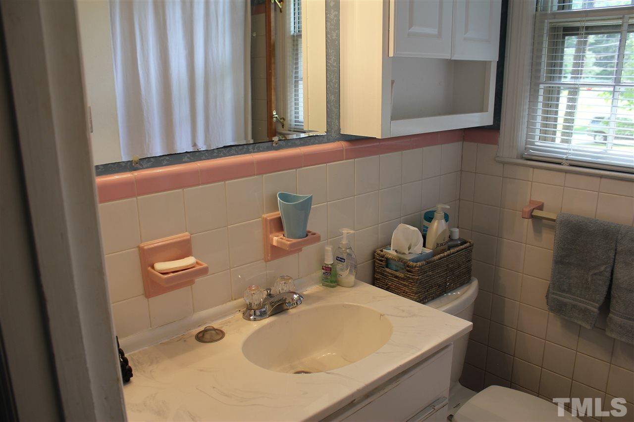 816 Macon Place Raleigh, NC 27609 - Photo 11 of 17 a bathroom with a sink and a mirror