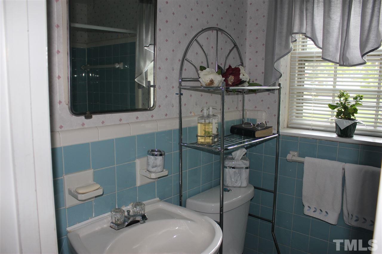 816 Macon Place Raleigh, NC 27609 - Photo 14 of 17 a bathroom with a sink a toilet and mirror