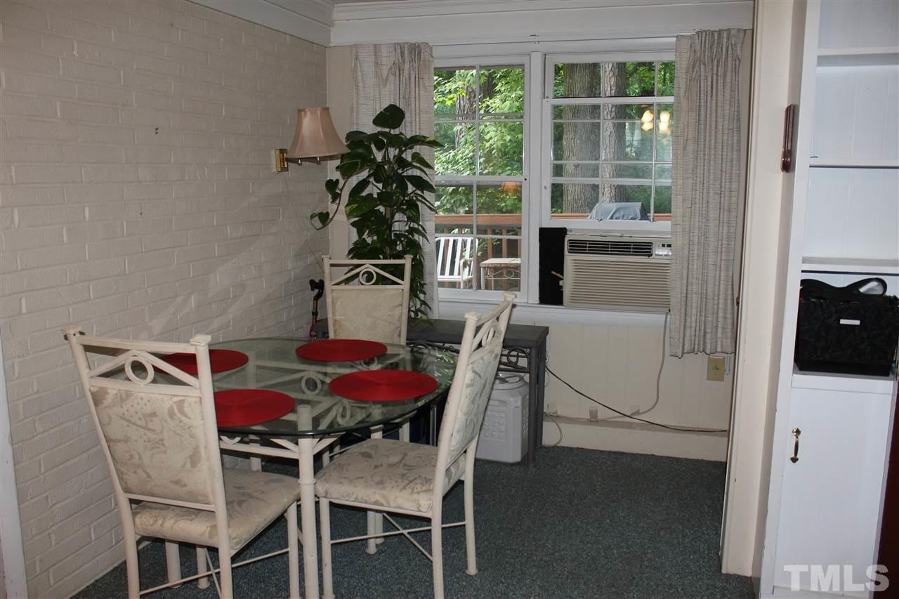 816 Macon Place Raleigh, NC 27609 - Photo 4 of 17 a view of a dining room with furniture and a potted plant