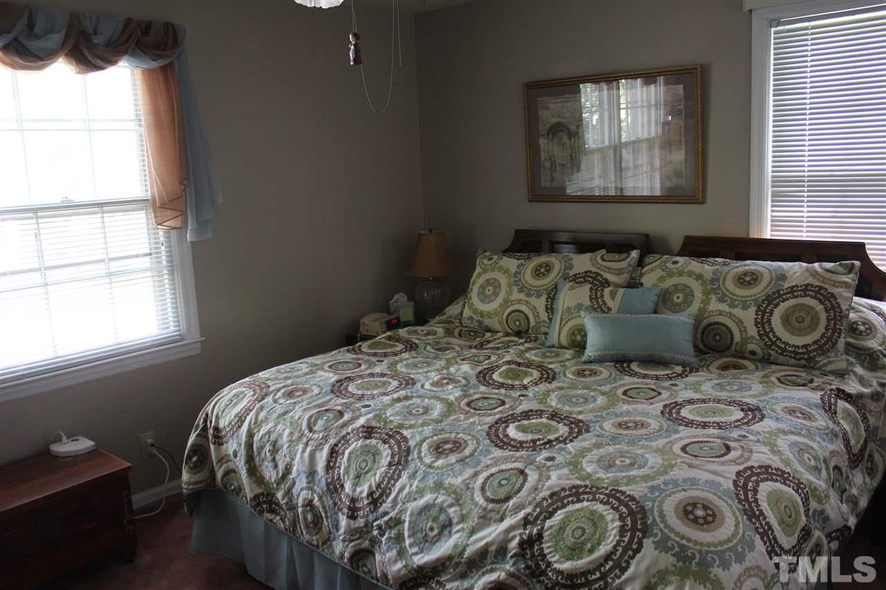 816 Macon Place Raleigh, NC 27609 - Photo 9 of 17 a bed sitting in a bedroom next to a window