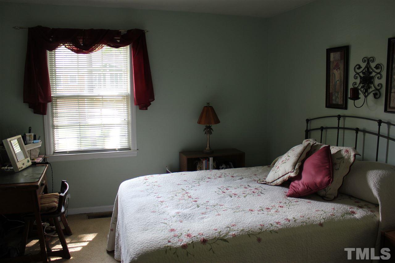 816 Macon Place Raleigh, NC 27609 - Photo 10 of 17 a bedroom with a bed and a window