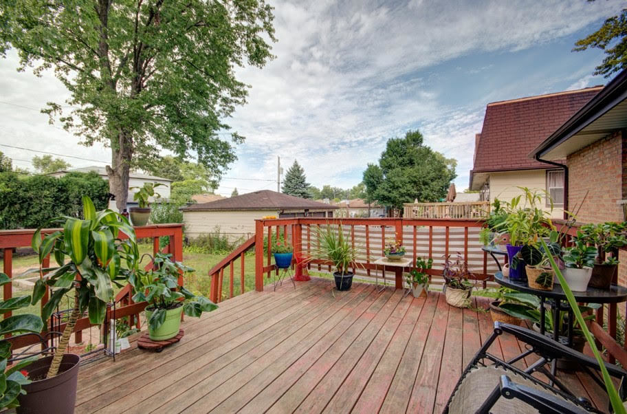 10828 Rutherford Avenue Worth, IL 60482 - Photo 22 of 25 a balcony with wooden floor and potted plants
