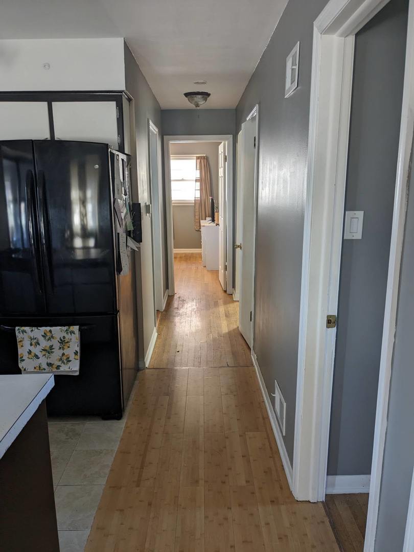 10828 Rutherford Avenue Worth, IL 60482 - Photo 5 of 25 a view of a hallway with wooden floor