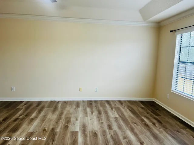 a view of wooden floor and brick walls