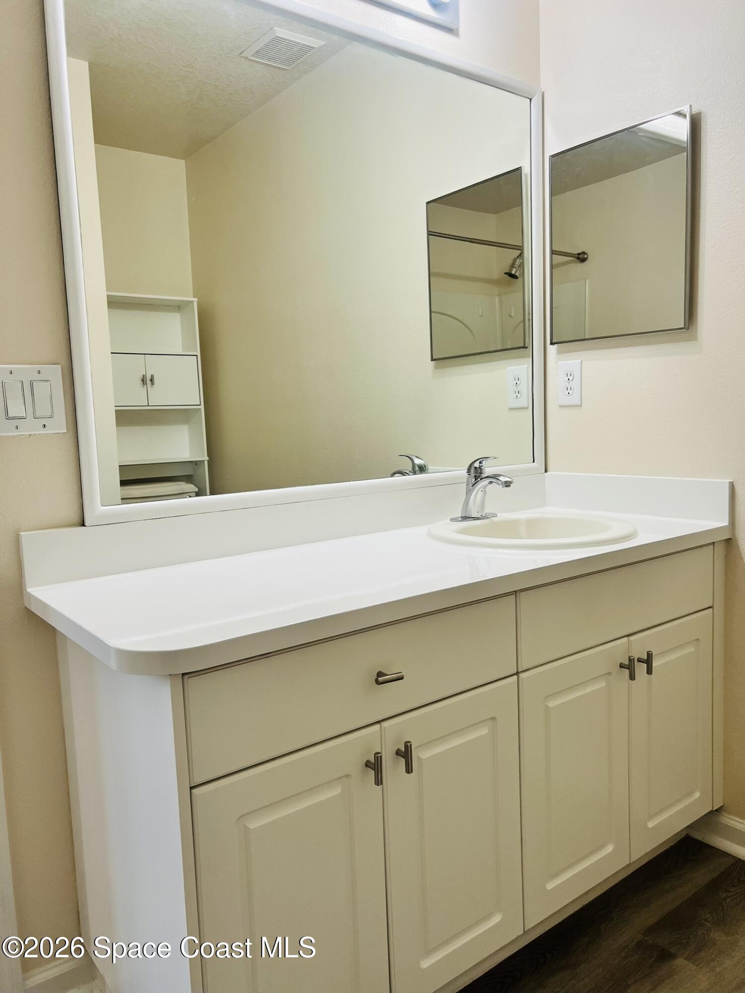 1145 Luminary Circle, Unit 104 Melbourne, FL 32901 - Photo 18 of 37 a bathroom with a sink and a mirror