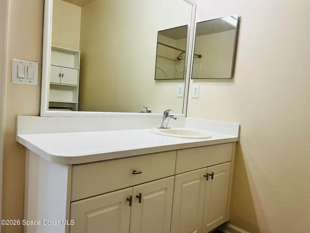 a bathroom with a sink and a mirror
