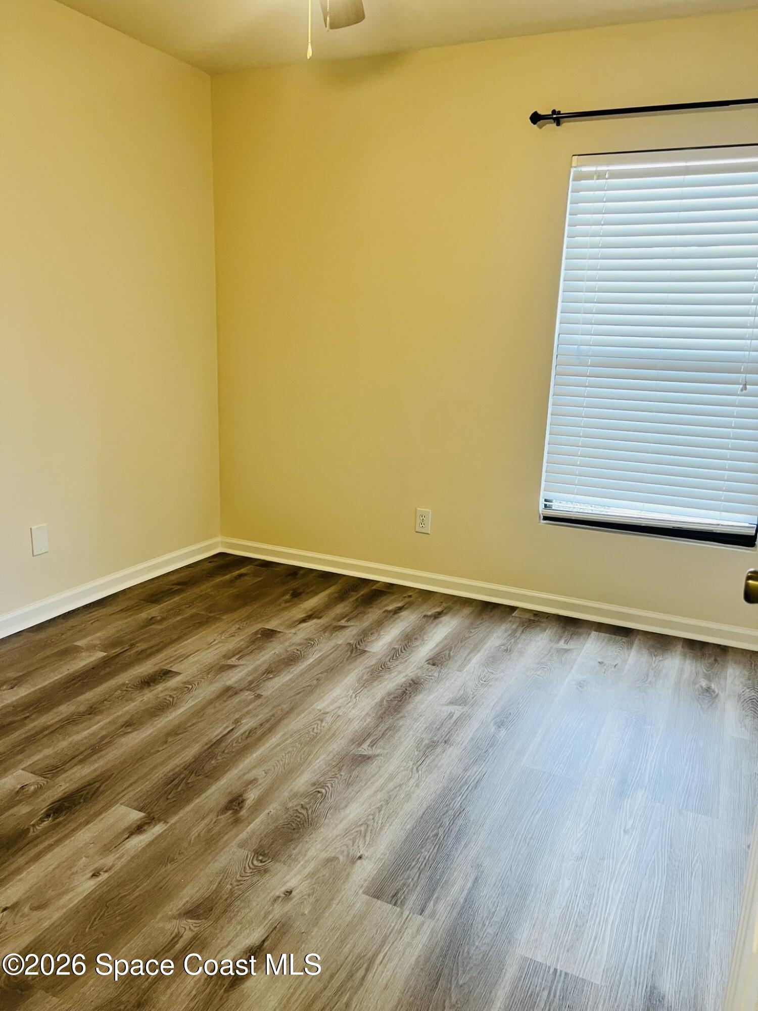 1145 Luminary Circle, Unit 104 Melbourne, FL 32901 - Photo 22 of 37 a view of a room with wooden floor and a window