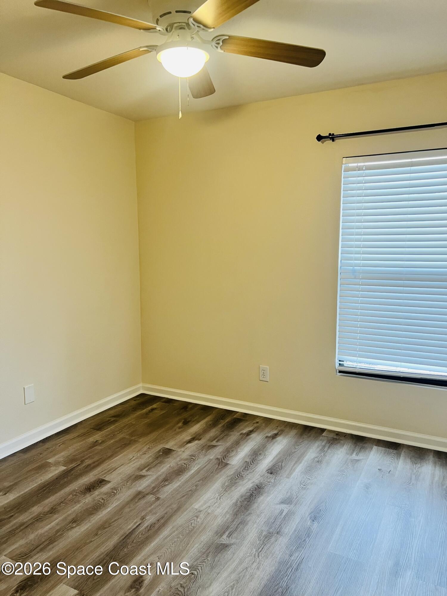 1145 Luminary Circle, Unit 104 Melbourne, FL 32901 - Photo 23 of 37 a view of a room with wooden floor and a window