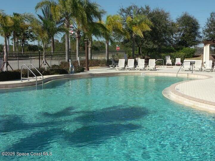 1145 Luminary Circle, Unit 104 Melbourne, FL 32901 - Photo 35 of 37 a view of a swimming pool with a patio