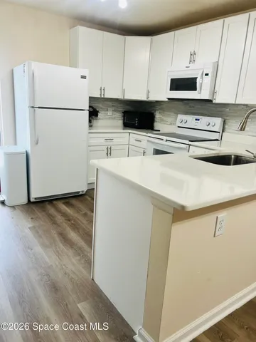 a white refrigerator freezer sitting in a kitchen