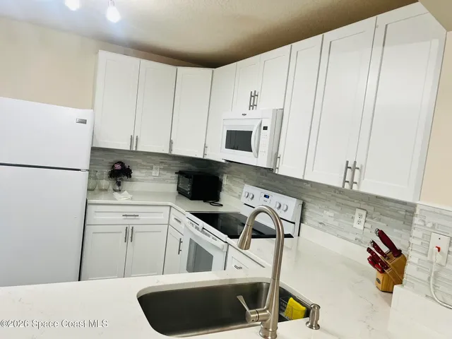 a kitchen with cabinets and appliances