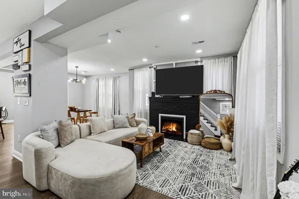 a living room with furniture and a fireplace