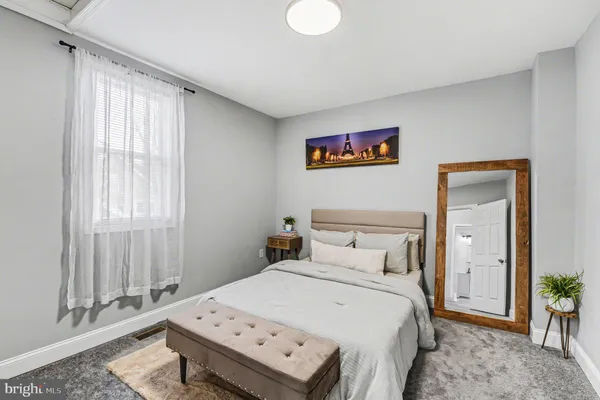 a bedroom with a bed and a window