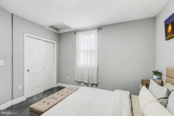a bedroom with a bed and a couch