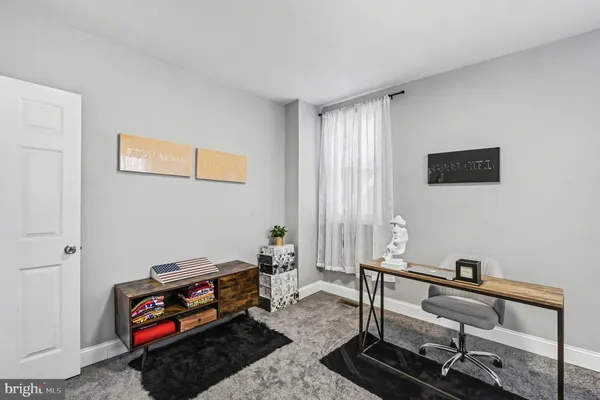 a living room with furniture a rug and a window