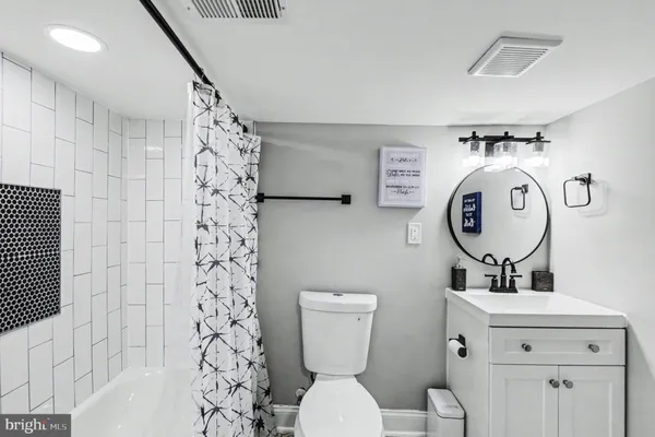a bathroom with a toilet a sink and a shower