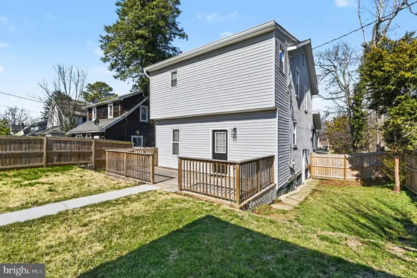 a view of backyard with a house and a large tree