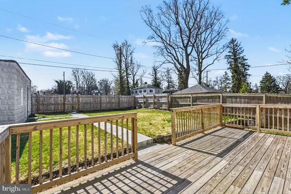 a view of balcony with wooden floor and fence