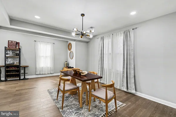 a view of a room with furniture and wooden floor