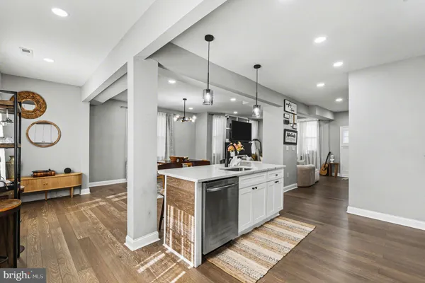 a kitchen with granite countertop a stove a sink and a refrigerator