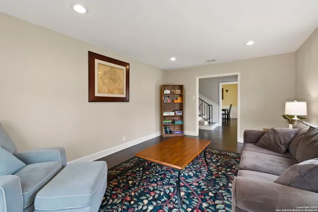 a living room with furniture and a rug