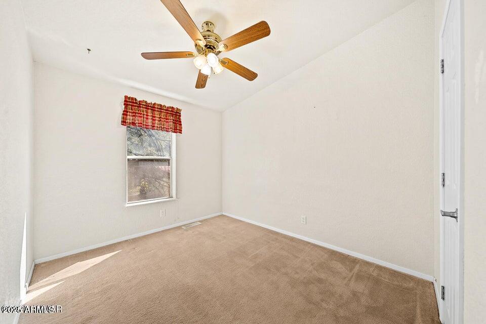 2421 West Thornton Road Show Low, AZ 85901 - Photo 34 of 48 an empty room with windows and fan
