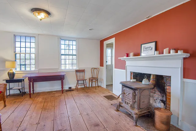 a view of an empty room and wooden floor