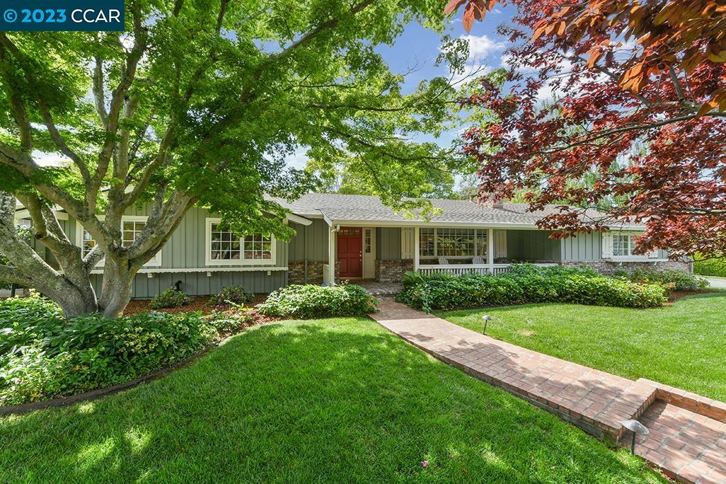 a front view of a house with a garden