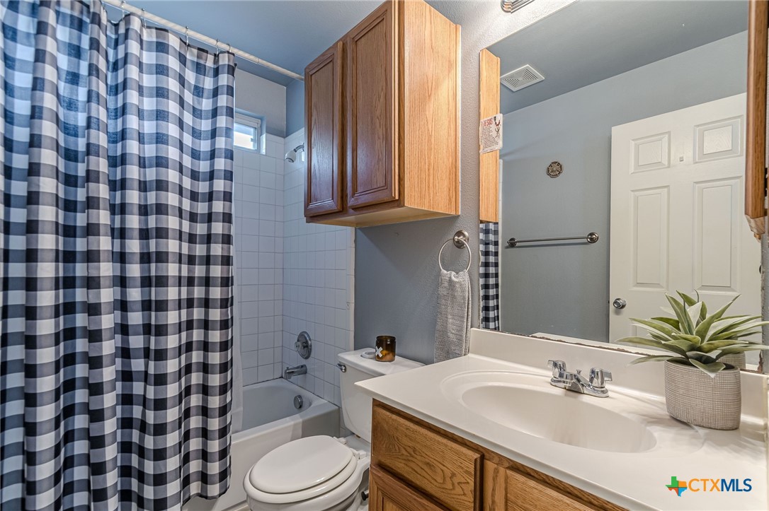 2369 Carson Loop New Braunfels, TX 78130 - Photo 16 of 28 a bathroom with a sink toilet and shower
