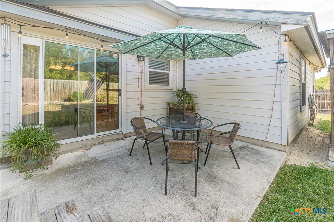 2369 Carson Loop New Braunfels, TX 78130 - Photo 19 of 28 a patio with table and chairs and potted plants