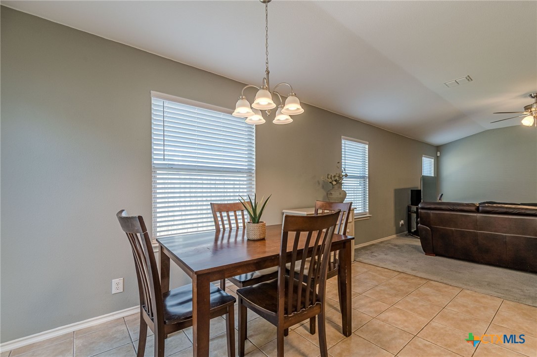 2369 Carson Loop New Braunfels, TX 78130 - Photo 7 of 28 a view of a dining room with furniture and wooden floor