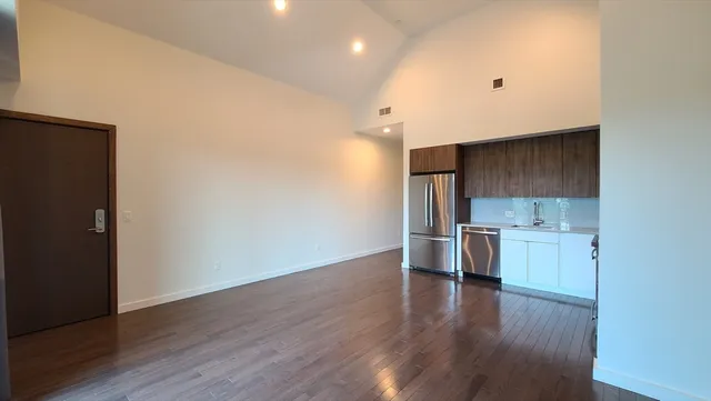 a view of a kitchen with a sink and a stove top oven