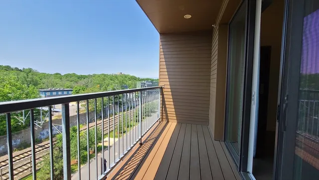 a view of balcony with wooden floor